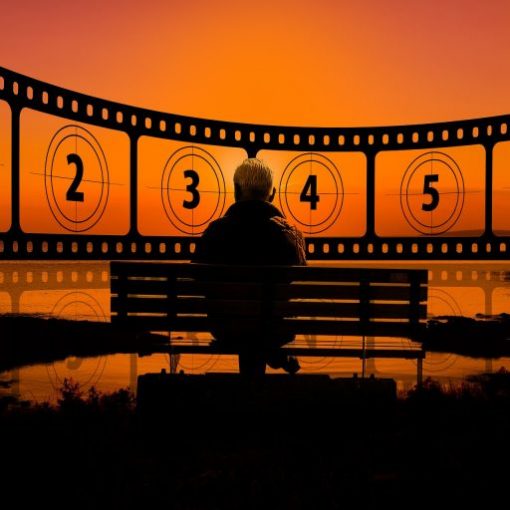 Man sitting on bench at sunset, with film countdown from 1 to 6 in the background.