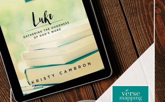 Tablet displaying Luke Bible study book by Kristy Cambron on wooden table with coffee cup.