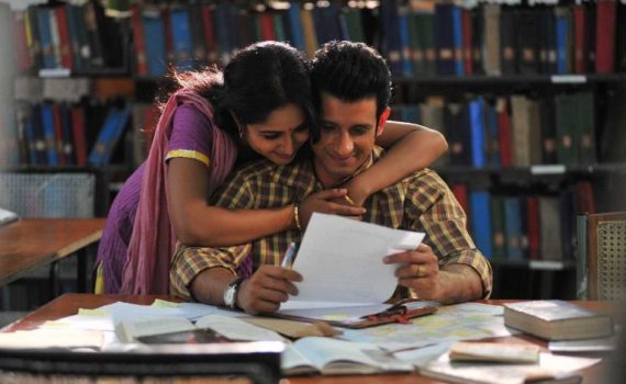 Couple reading together in library, smiling, surrounded by books.