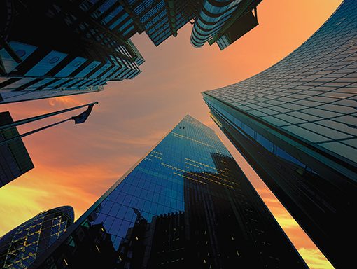 Skyscrapers against a vibrant sunset sky, showcasing modern architecture and urban design.